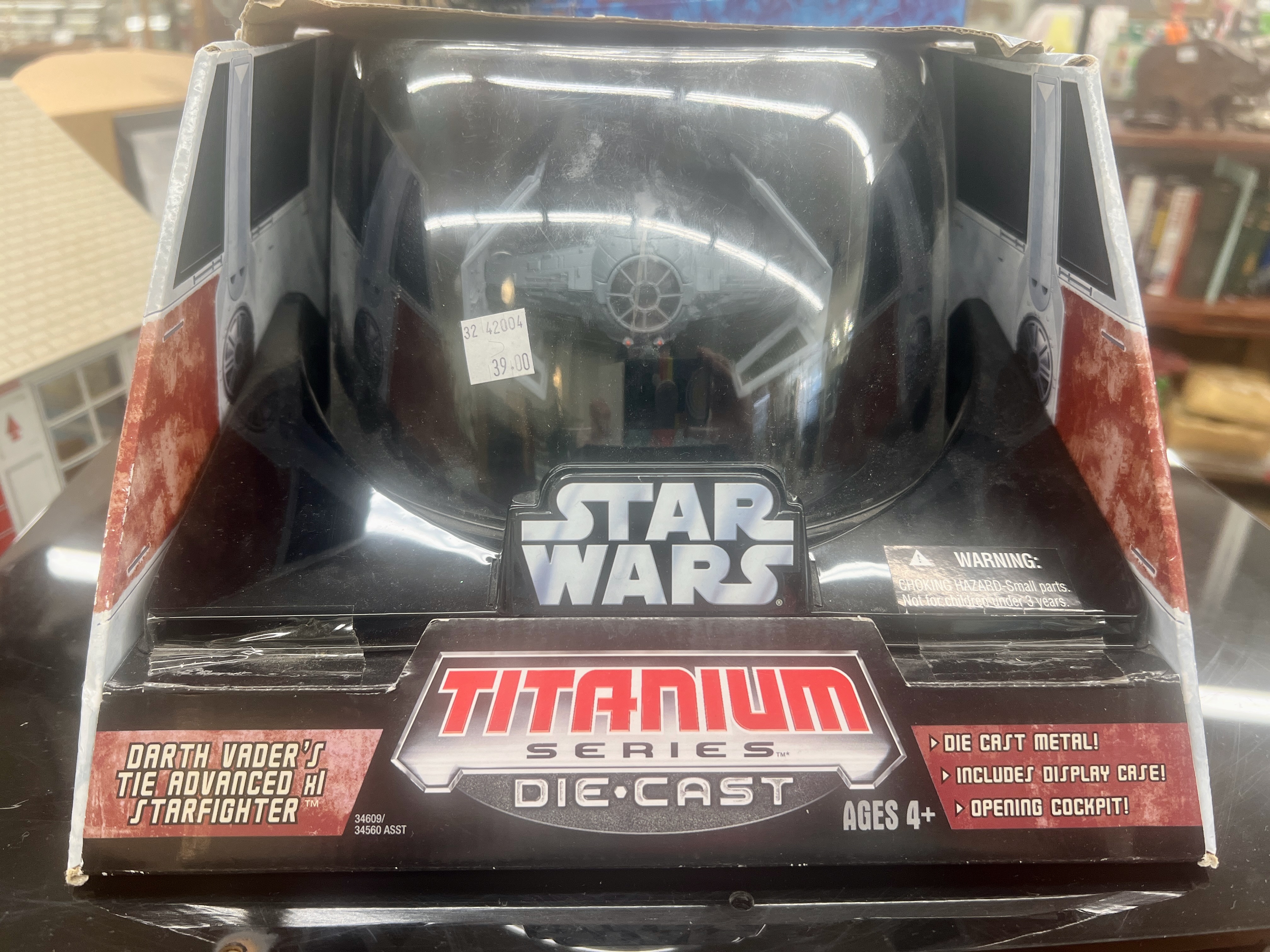 A toy, Darth Vader's TIE fighter, in its original packaging.